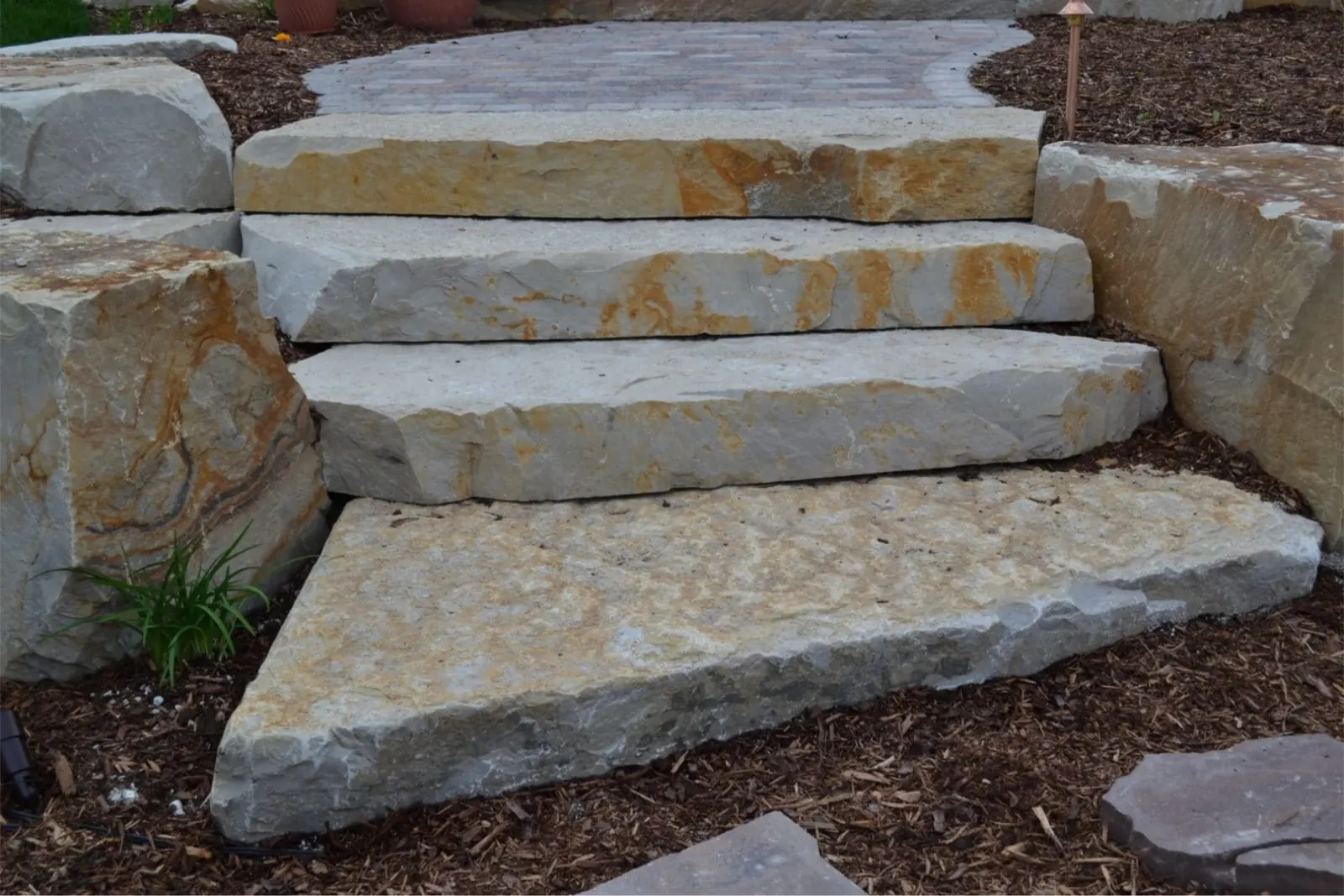 Finished natural stone steps with paver walkway and landscape lighting