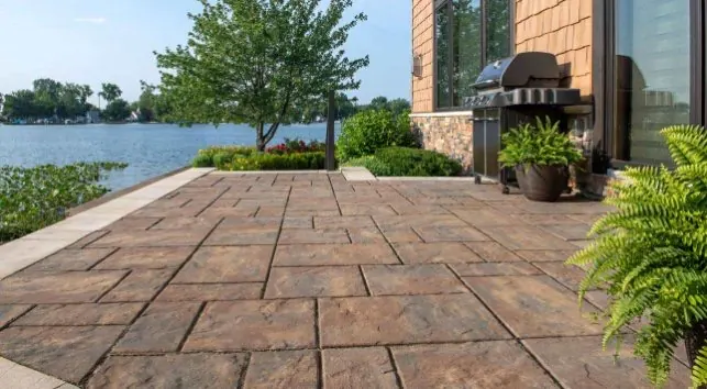 Waterfront paver patio with outdoor grill station and lake view